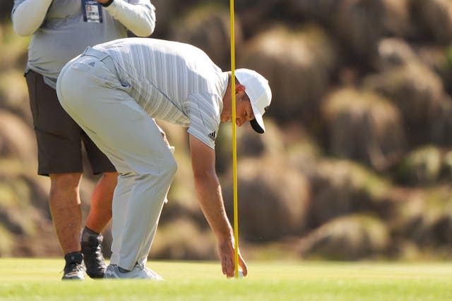 Sergio Garcia retrieves his ball after hitting a hole in one