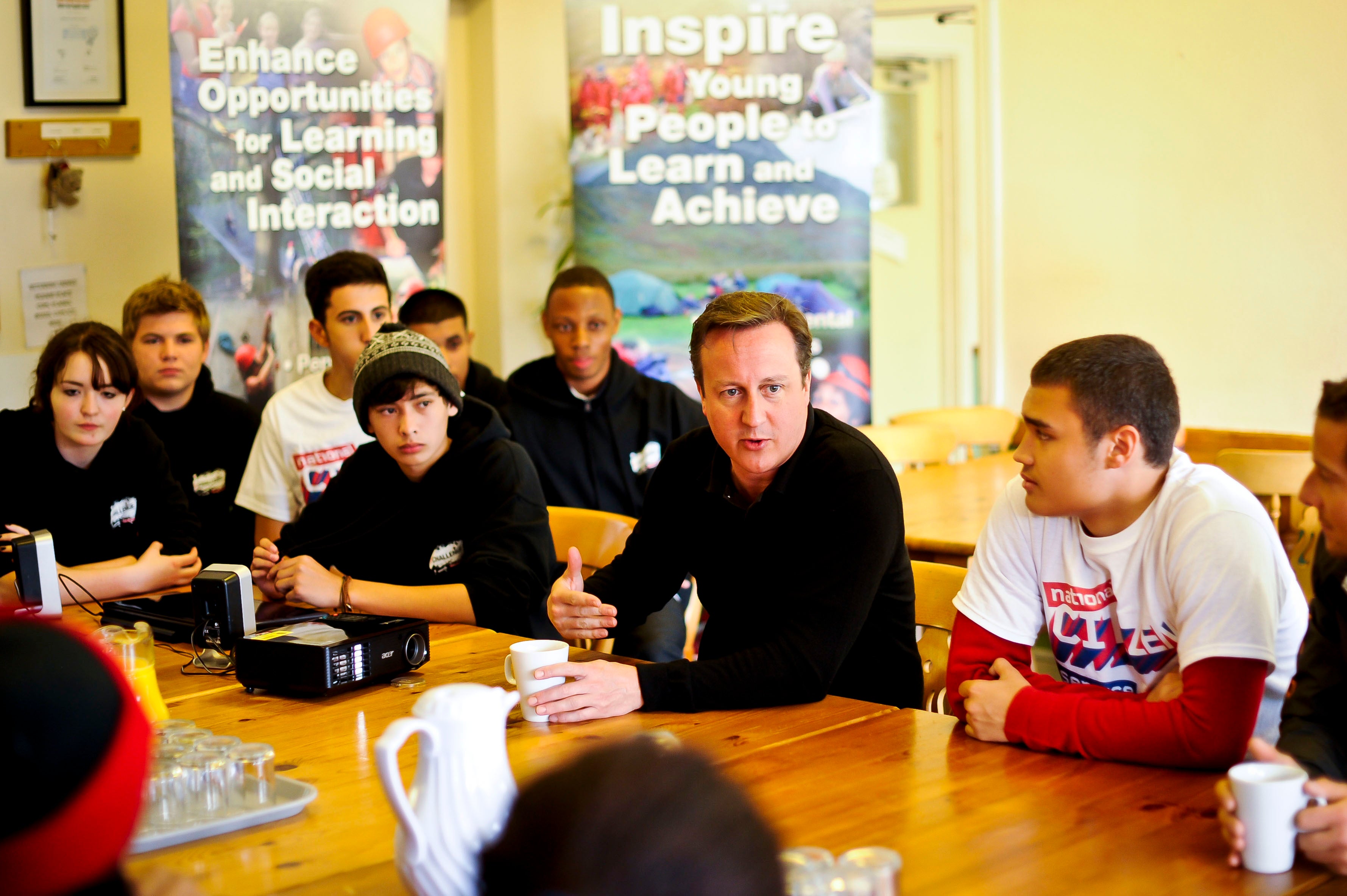 Cameron speaks to teenagers at a scheme in Wales in 2012