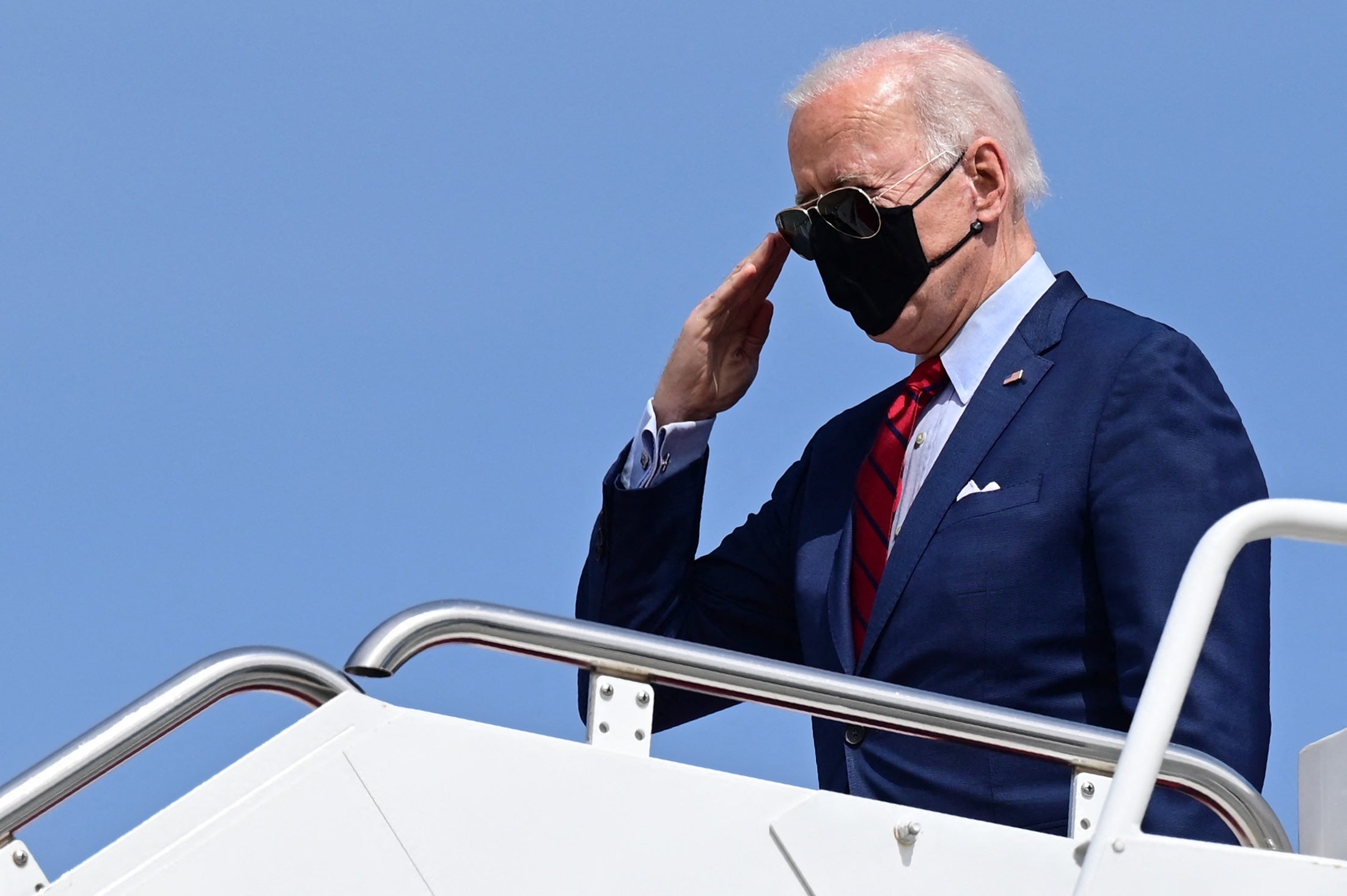 <p>President Joe Biden salutes as he boards Air Force One. The sooner Americans and Britons can take to the air again, the better</p>