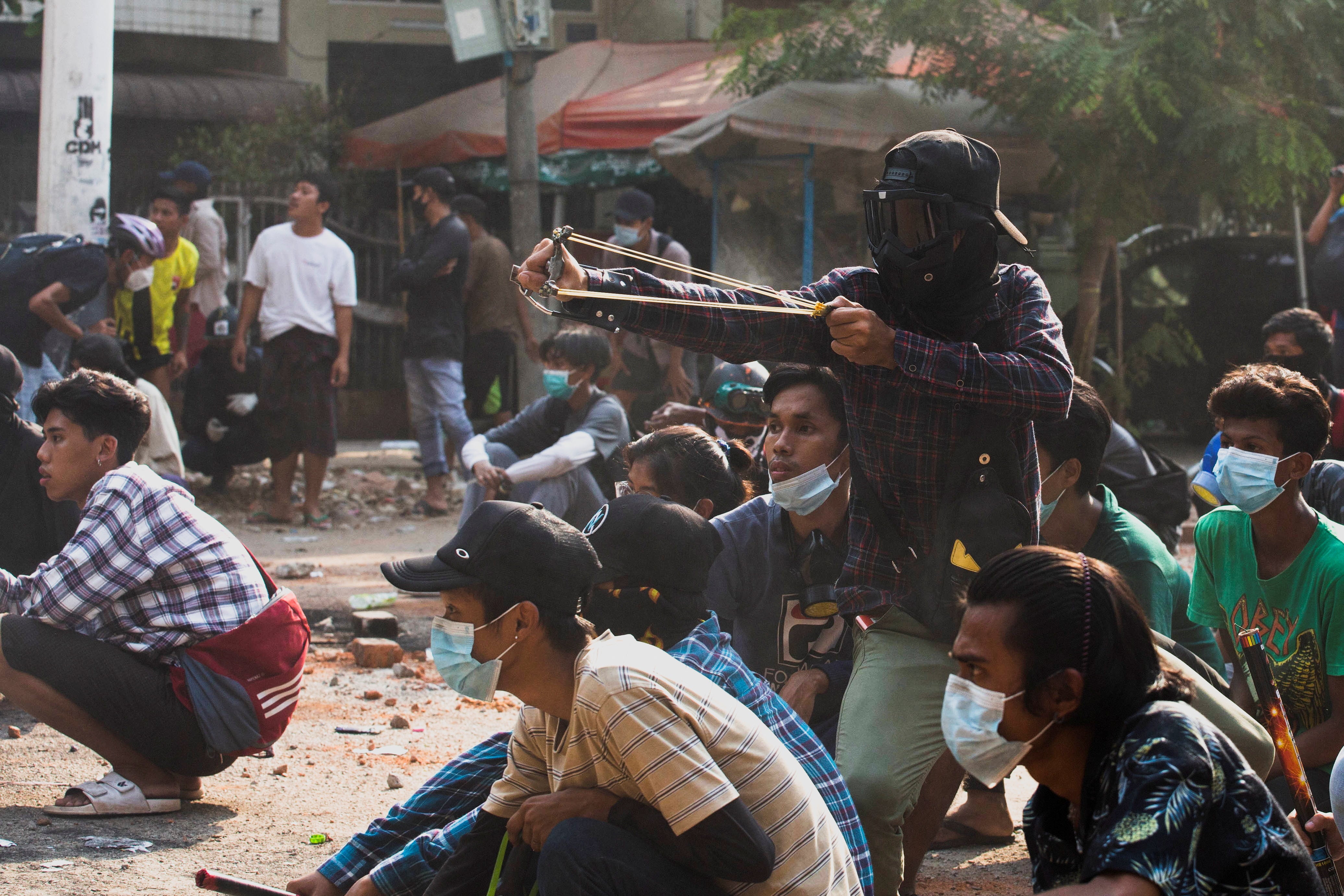 Myanmar protestors have launched “garbage strike” — a new civil disobedience strategy. File photo of a protestor using a slingshot.