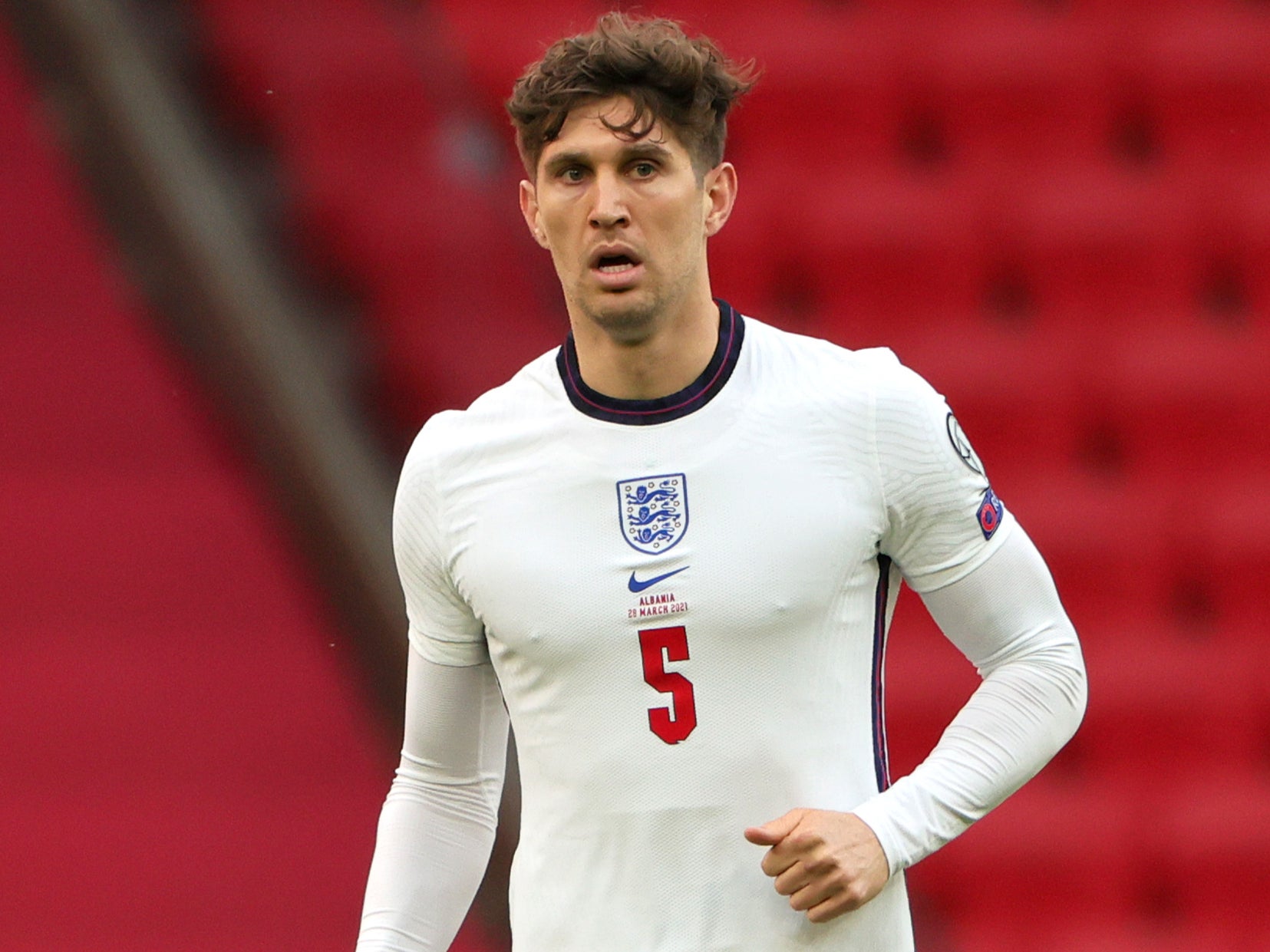  John Stones, left, and Marc Guehi, right, two English soccer players, are playing soccer.