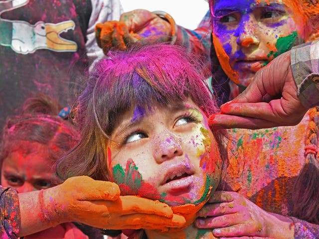 <p>A child is covered in coloured powder during <em>Holi</em> celebrations in Amritsar</p>