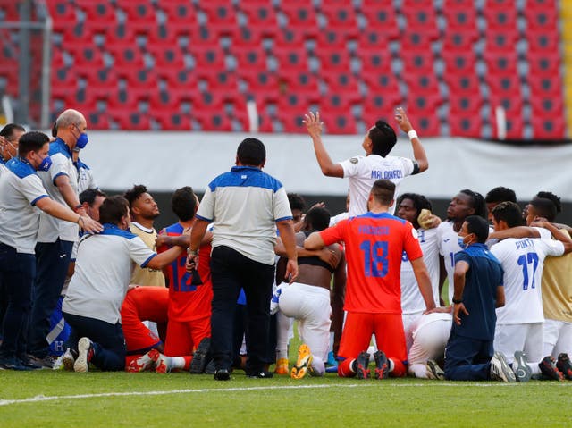 <p>Honduras players and staff celebrate beating the United States</p>