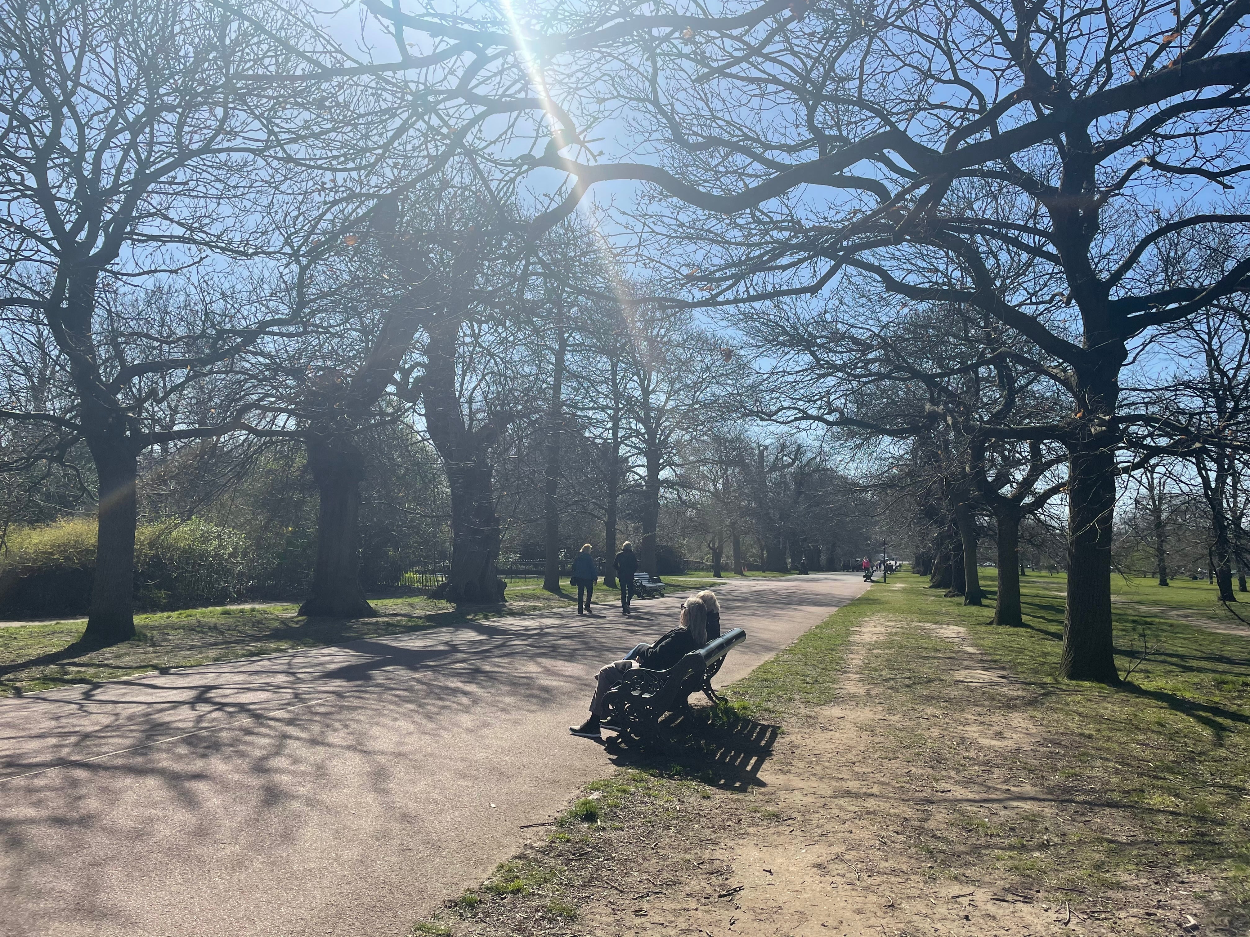 People meet friends for a walk or to sit on a bench in Greenwich Park on 29 March 2021, when lockdown restrictions have eased to allow up to six people or two households to meet outdoors in England