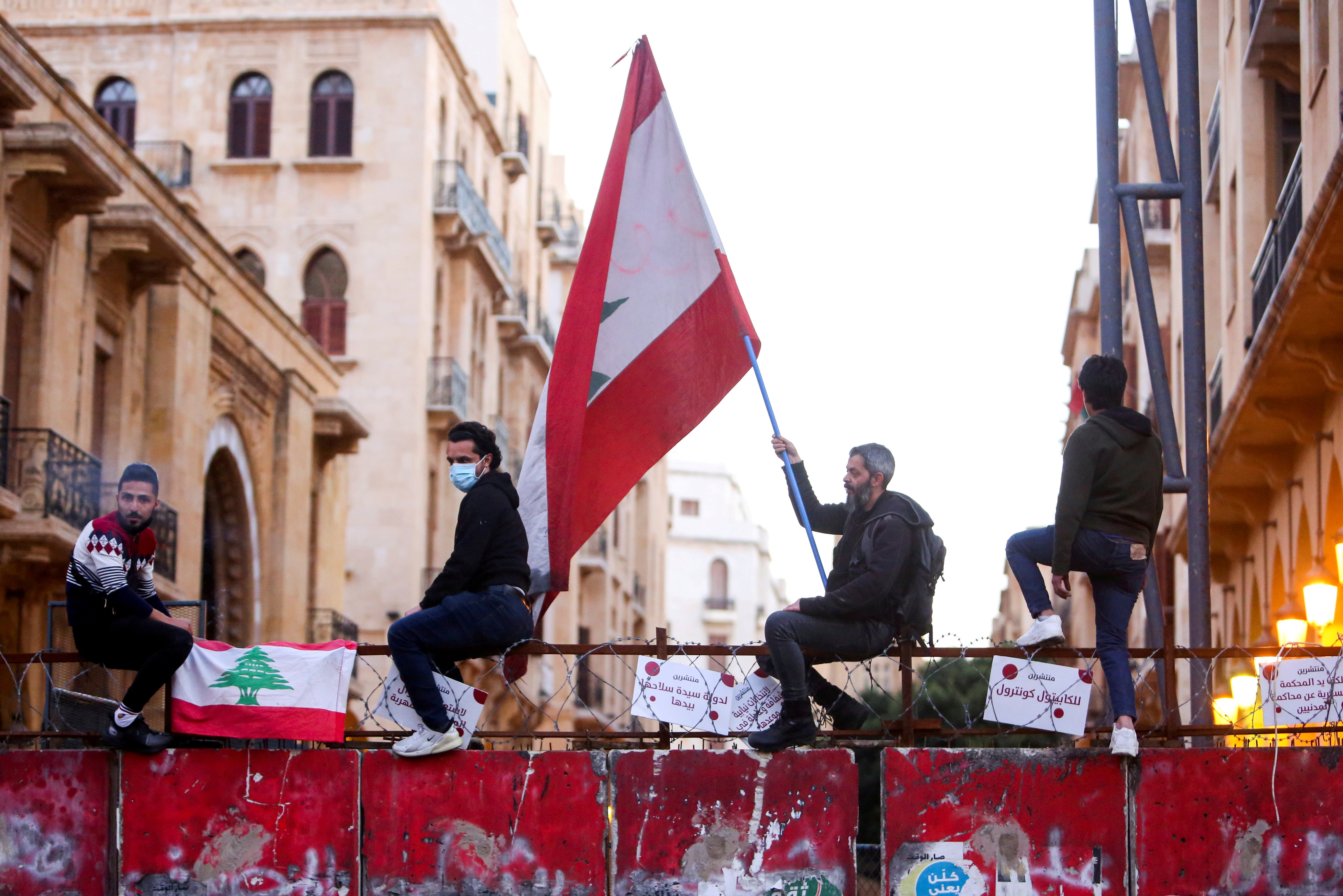 A demonstrator holds a Lebanese flag during a protest against the fall in Lebanese pound currency and mounting economic hardships earlier this month