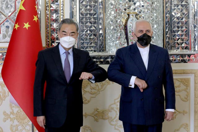 Iranian Foreign Minister Mohammad Javad Zarif, right, and his Chinese counterpart Wang Yi