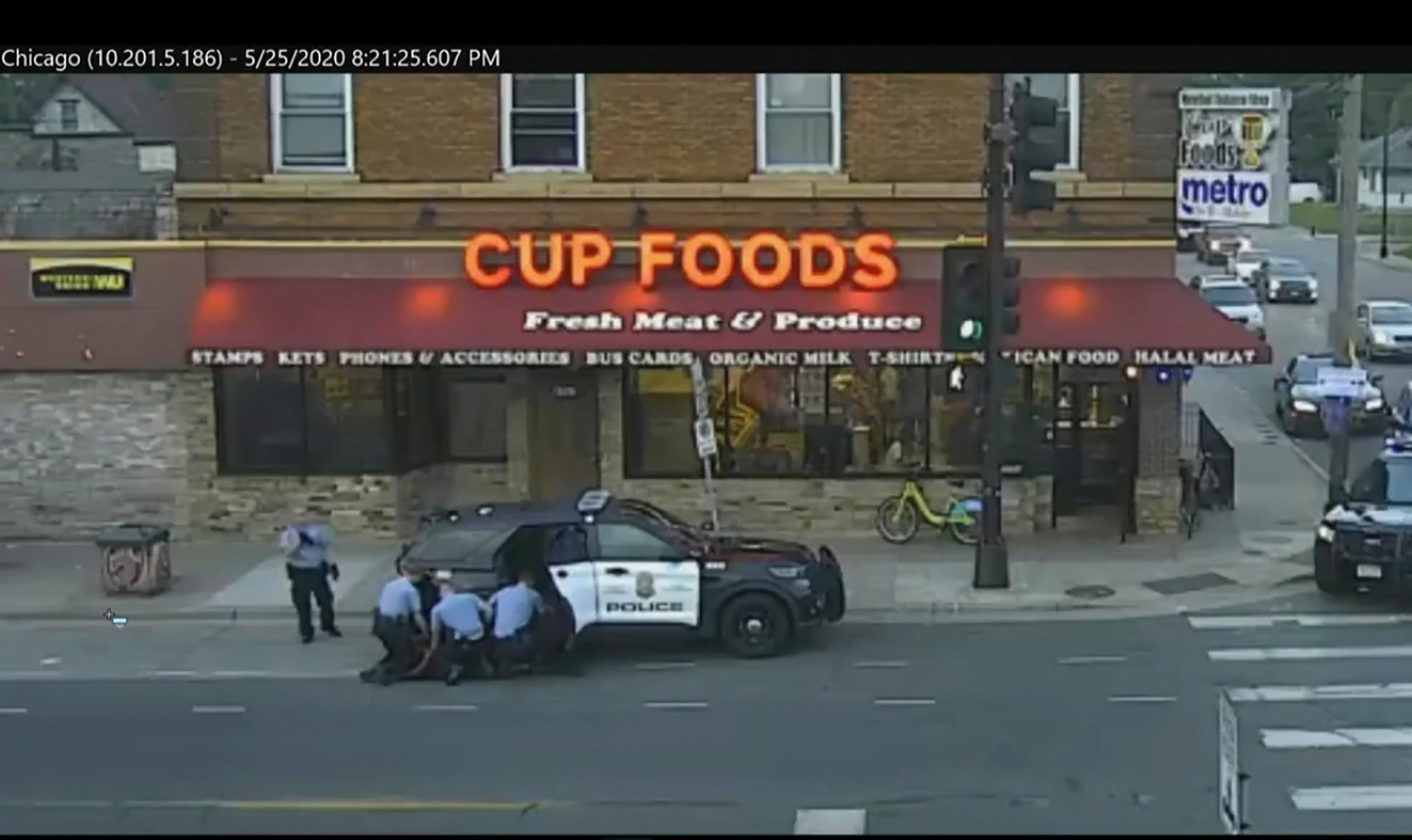 A city-operated security camera shows officers kneeling on George Floyd’s back during his fatal arrest.