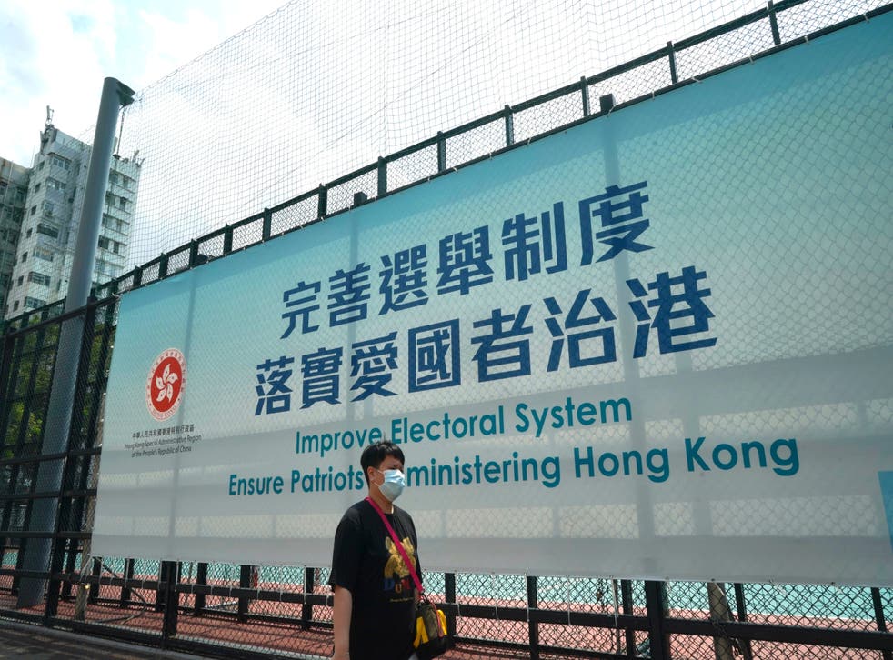 <p>Man walks past a government advertisement to promote the new Hong Kong electoral system reform, in Hong Kong, 30 March, 2021</p>