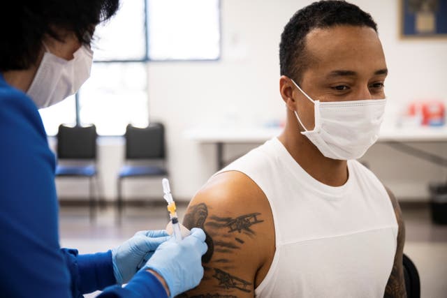 Dashon Bates, 28, receives his coronavirus disease (COVID-19) vaccine as vaccine eligibility expands to anyone over the age of 16 at the Bradfield Community Center through Health Partners of Western Ohio in Lima, Ohio