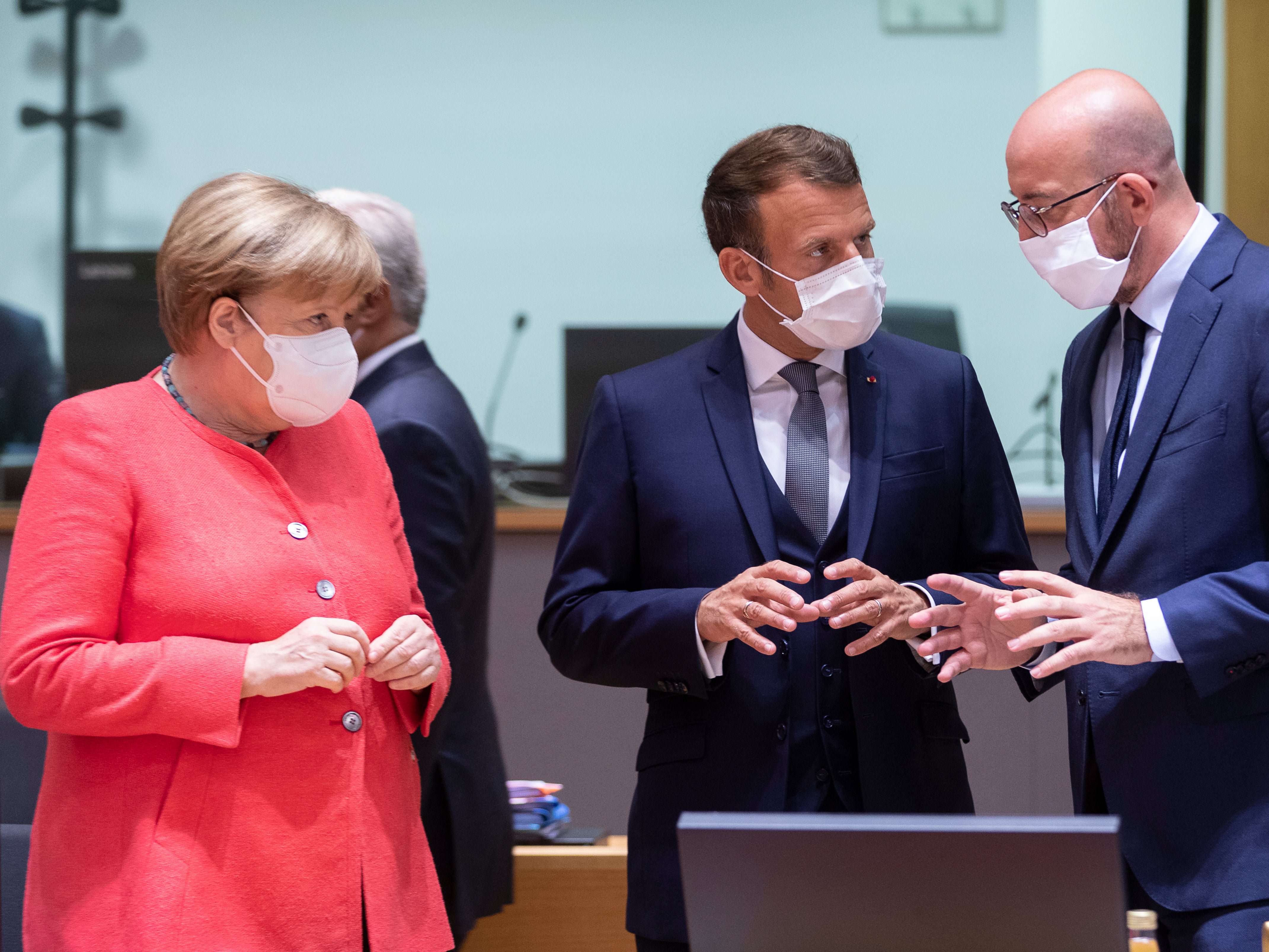 Angela Merkel talks with Emmanuel Macron