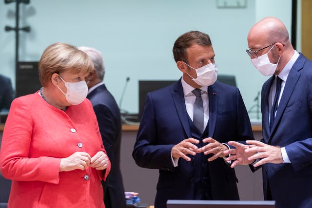 Angela Merkel talks with Emmanuel Macron