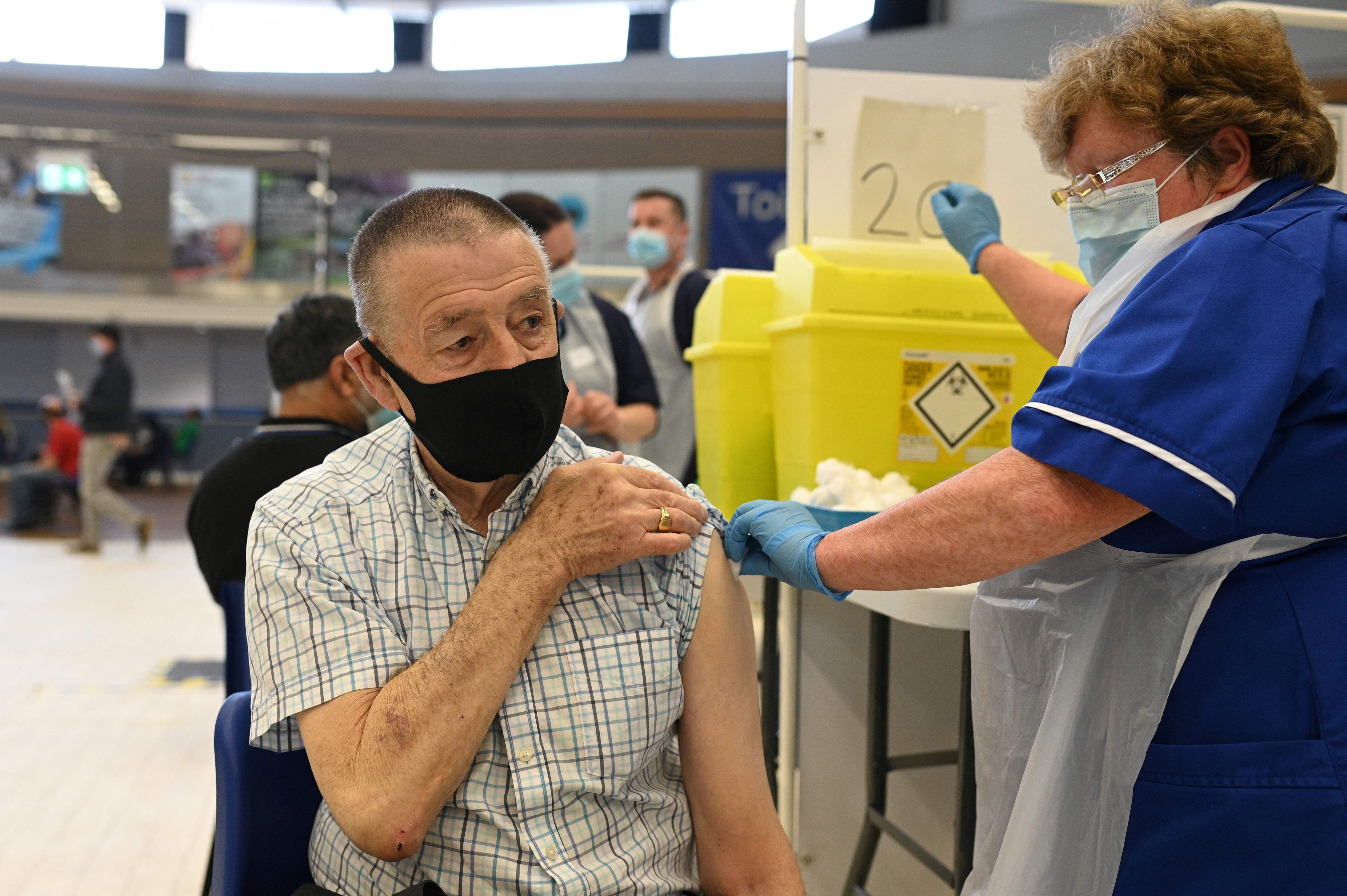 A dose of the Pfizer Covid-19 vaccine is administered at a clinic in the Derby Arena