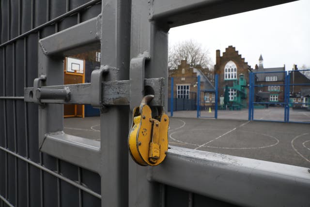 File photo of a lock hanging on a school gate in London