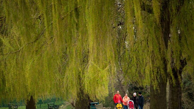 A family walks in St Nicholas' Park in Warwick, the hot weather which baked much of the UK this week is set to give way to a chilly Easter weekend. 