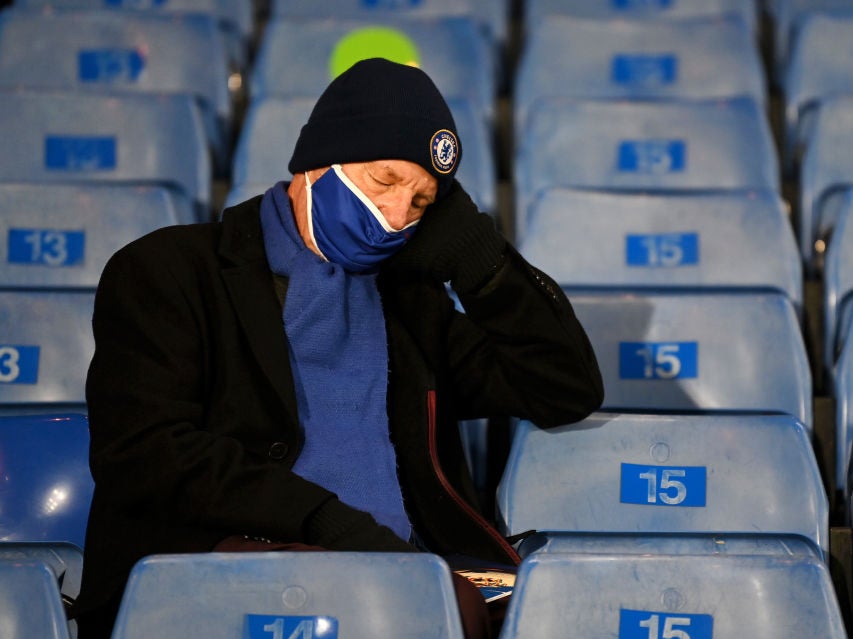 A Chelsea fan appears to fall asleep during a game