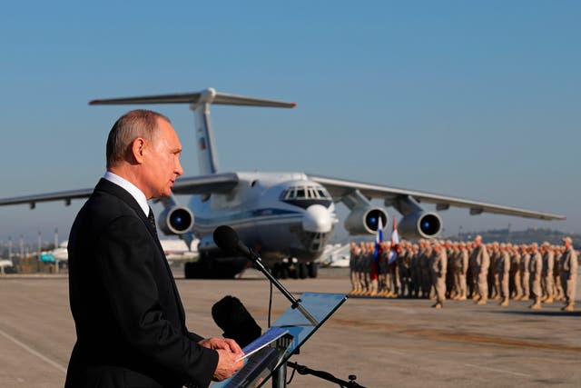<p>Russian president Vladimir Putin addresses the troops at the Hemeimeem air base in Syria, in December 2017</p>