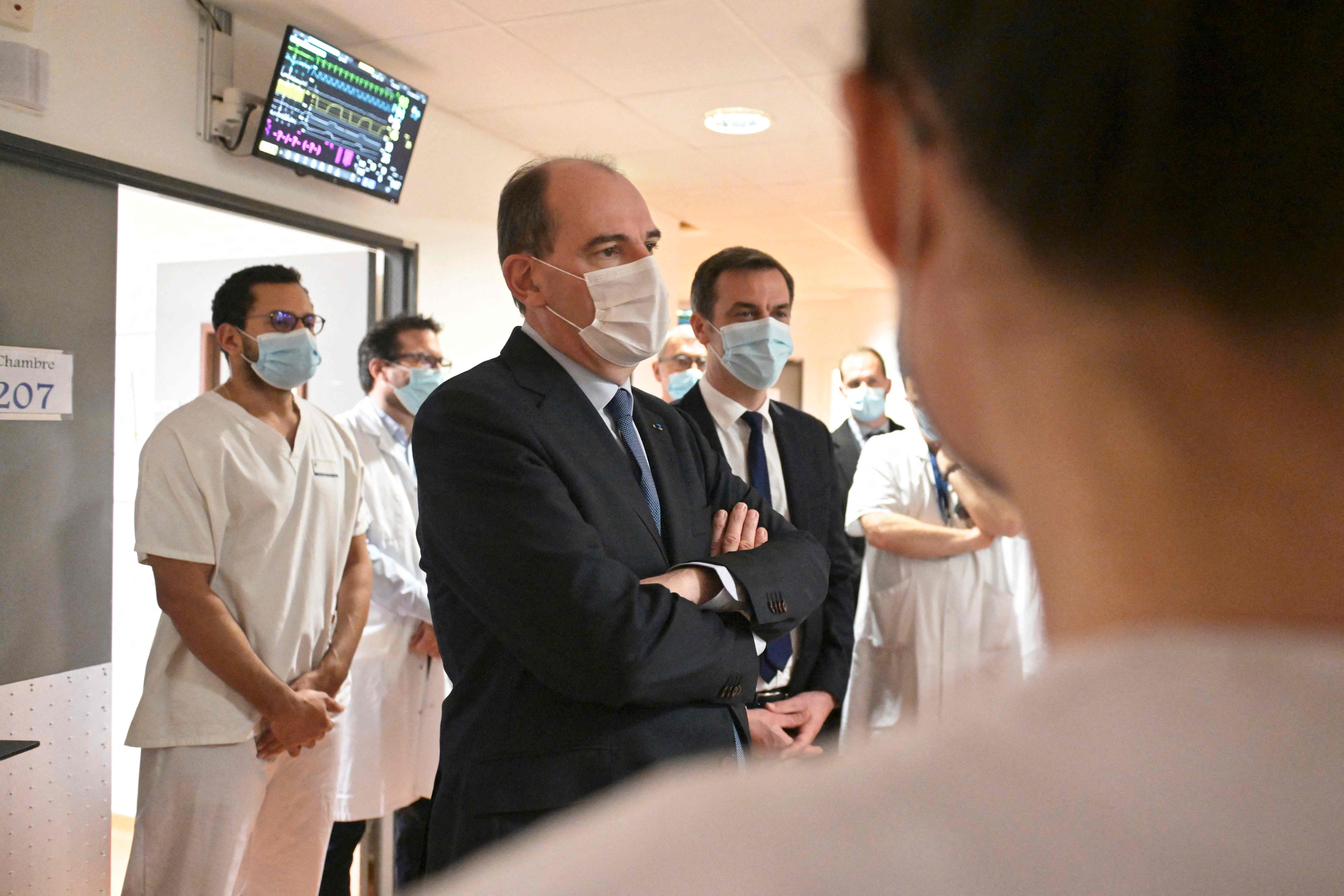 French prime minister Jean Castex (centre) and French health minister Olivier Veran (right) meet medical staff during a visit to Tours' hospital in central France on 2 April