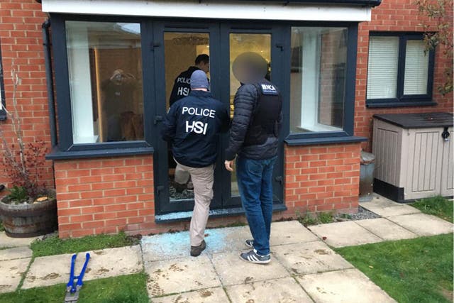 <p>Police entering a property as part of an investigation into a gang selling large quantities of ecstasy around the world on the dark web</p>