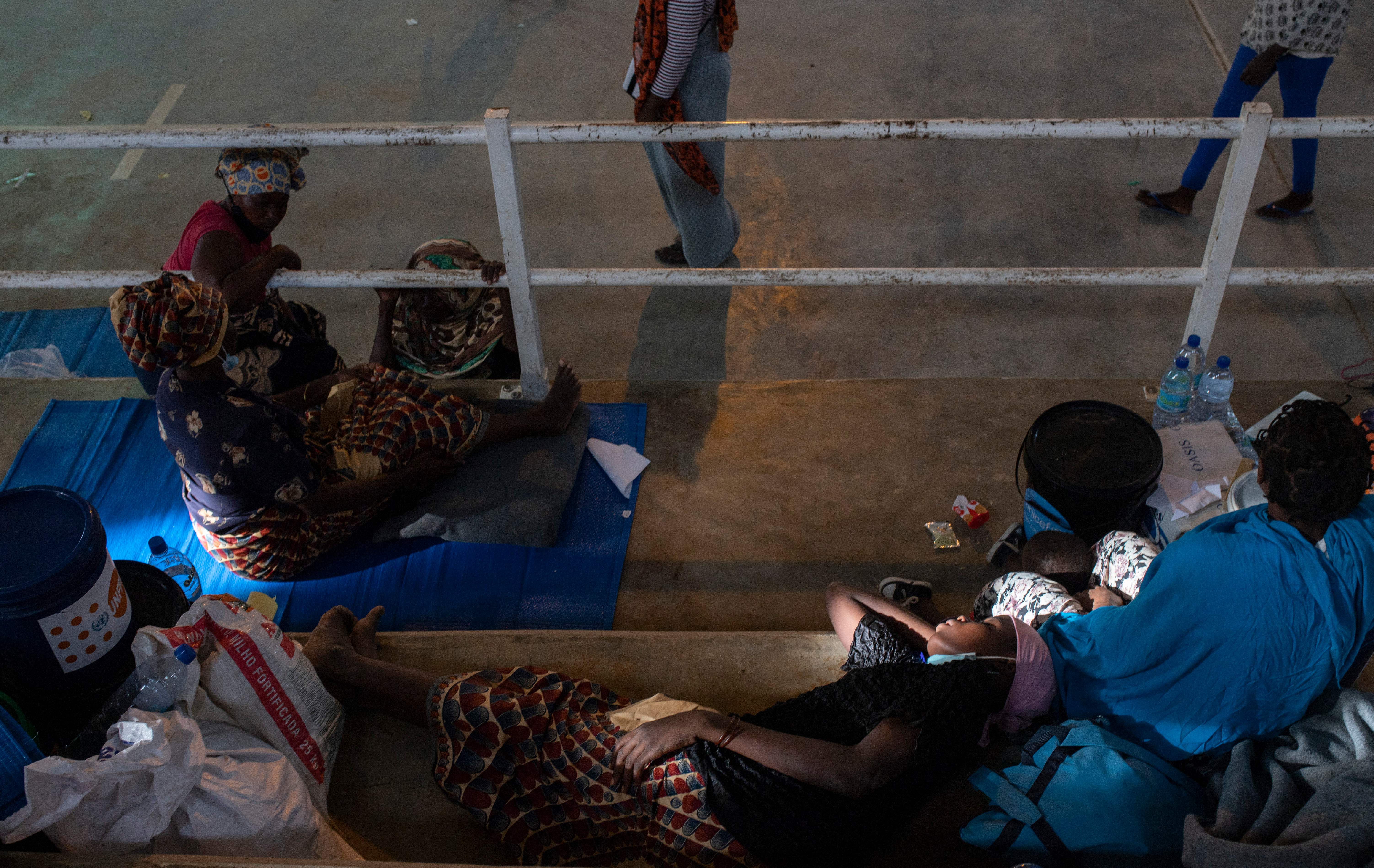 An internally displaced woman from Palma sleeps at a sports centre in Pemba