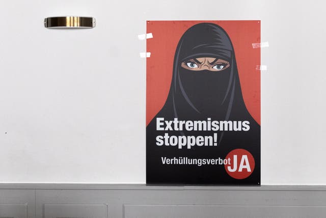 <p>A poster saying 'Stop Extremism' hangs on a wall at the meeting place of the supporters of the burqa ban initiative, in Bern</p>