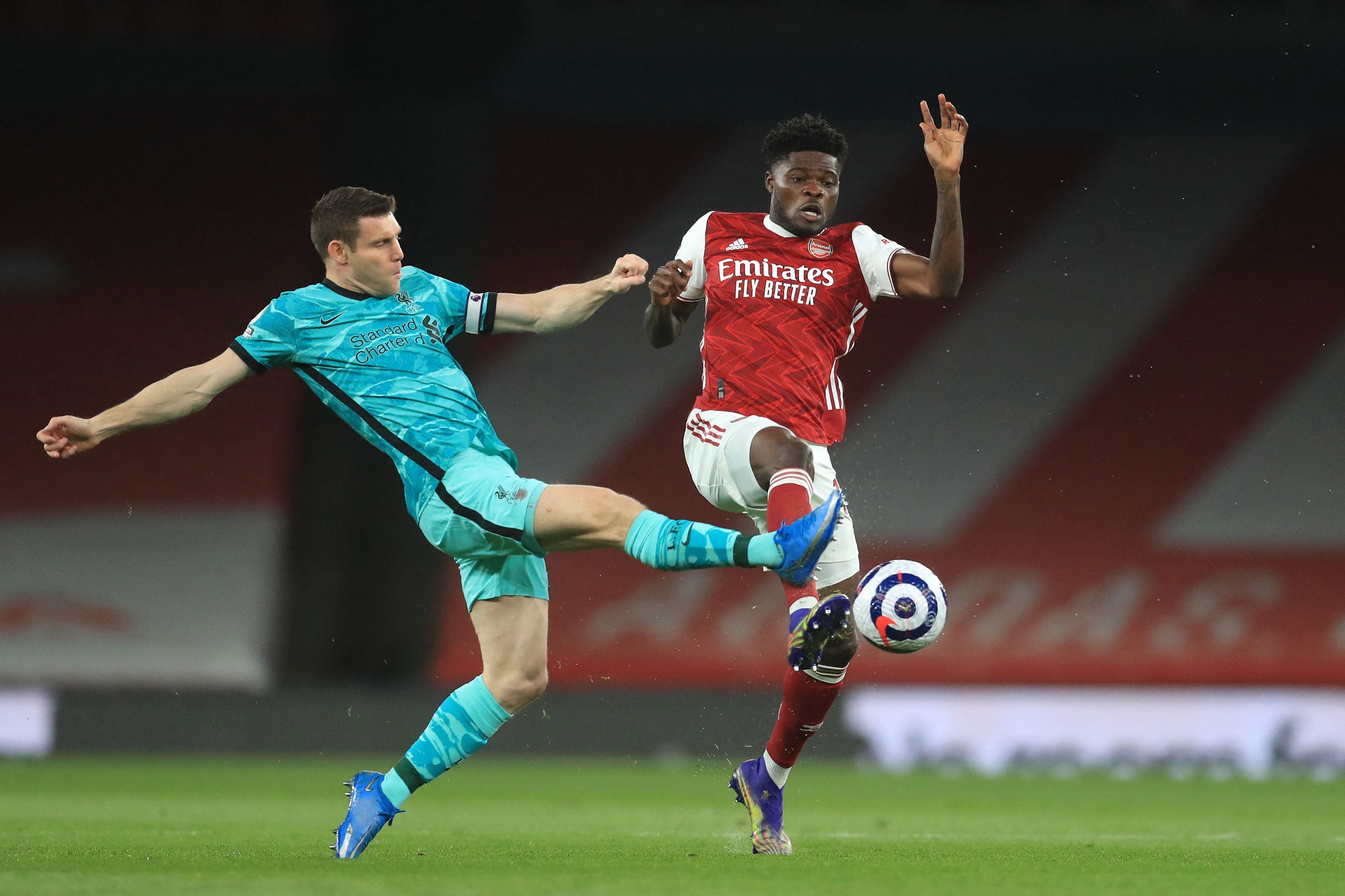 James Milner battles with Thomas Partey for the ball