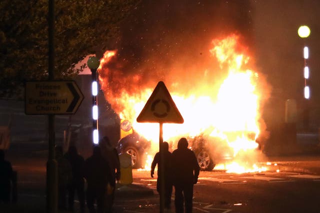 <p>Masked loyalists after hijacking and setting a car on fire at the Cloughfern roundabout in Newtownabbey on Saturday night</p>