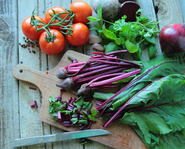 Fresh vegetables on a chopping board (Alamy/PA)