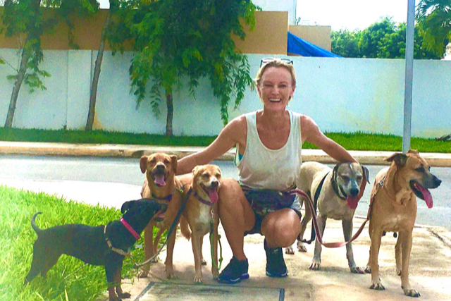 <p>Ynez Tulsen and her adopted street dogs</p>