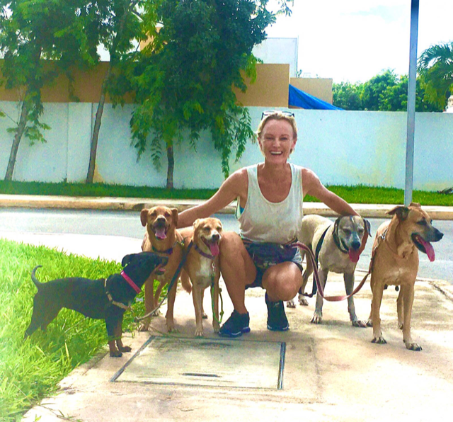 <p>Ynez Tulsen and her adopted street dogs</p>