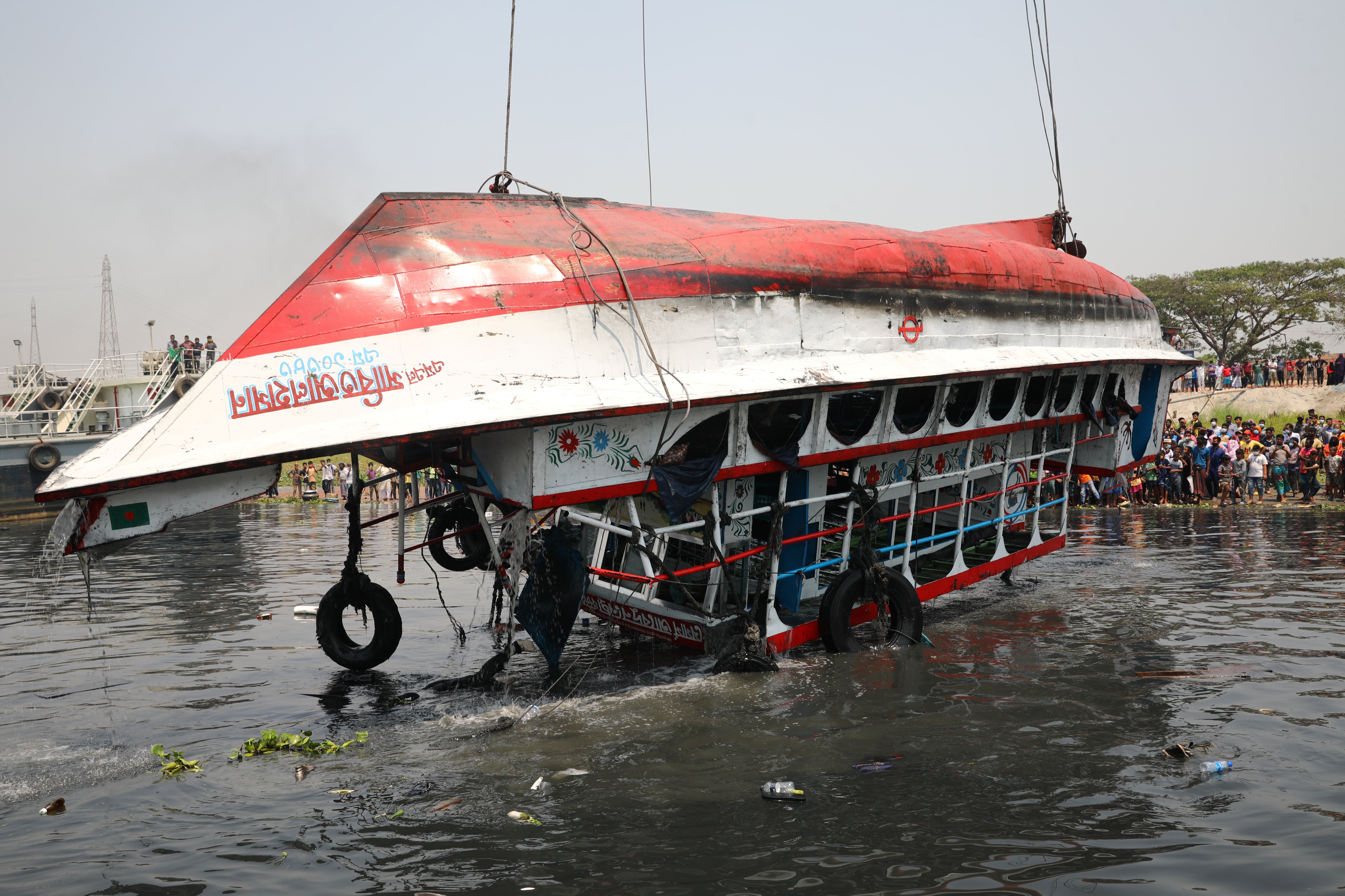 The ferry that collided with a cargo vessel and sank on Sunday is pulled from the river