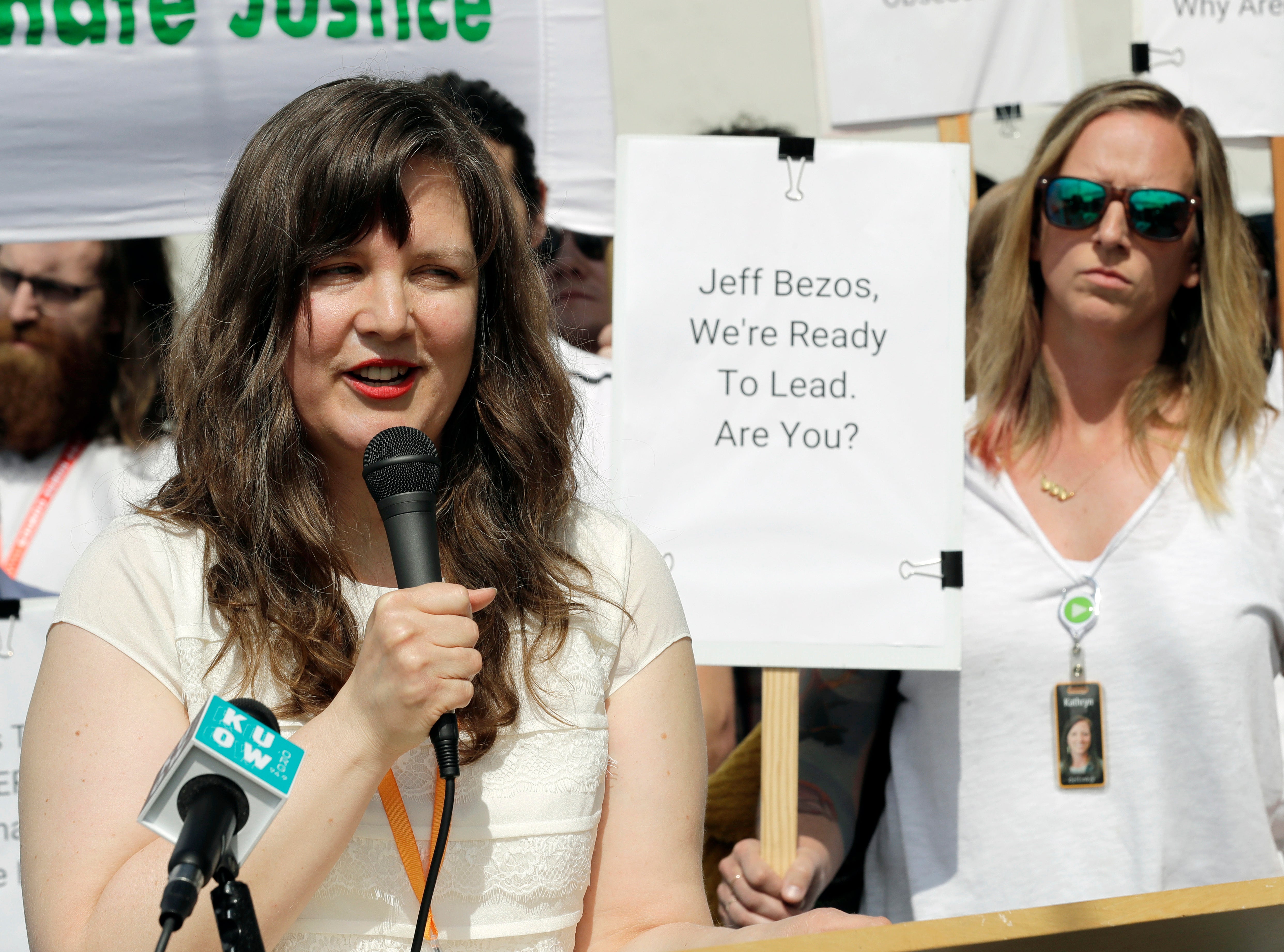 File: Emily Cunningham, left, speaks during a news conference following Amazon's annual shareholders meeting, May 2019, in Seattle