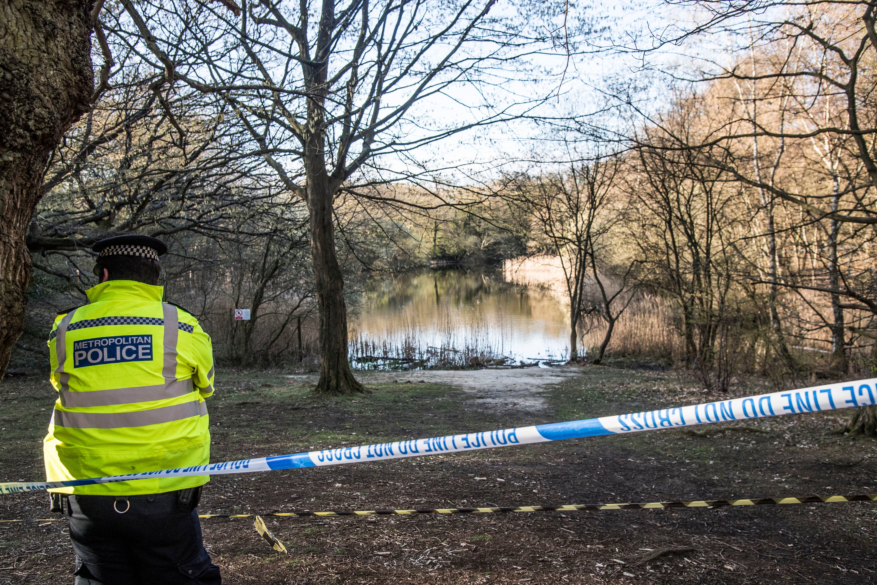 Metropolitan Police officers at the scene at the Wake Valley pond in Epping Forest following the discovery of a man's body