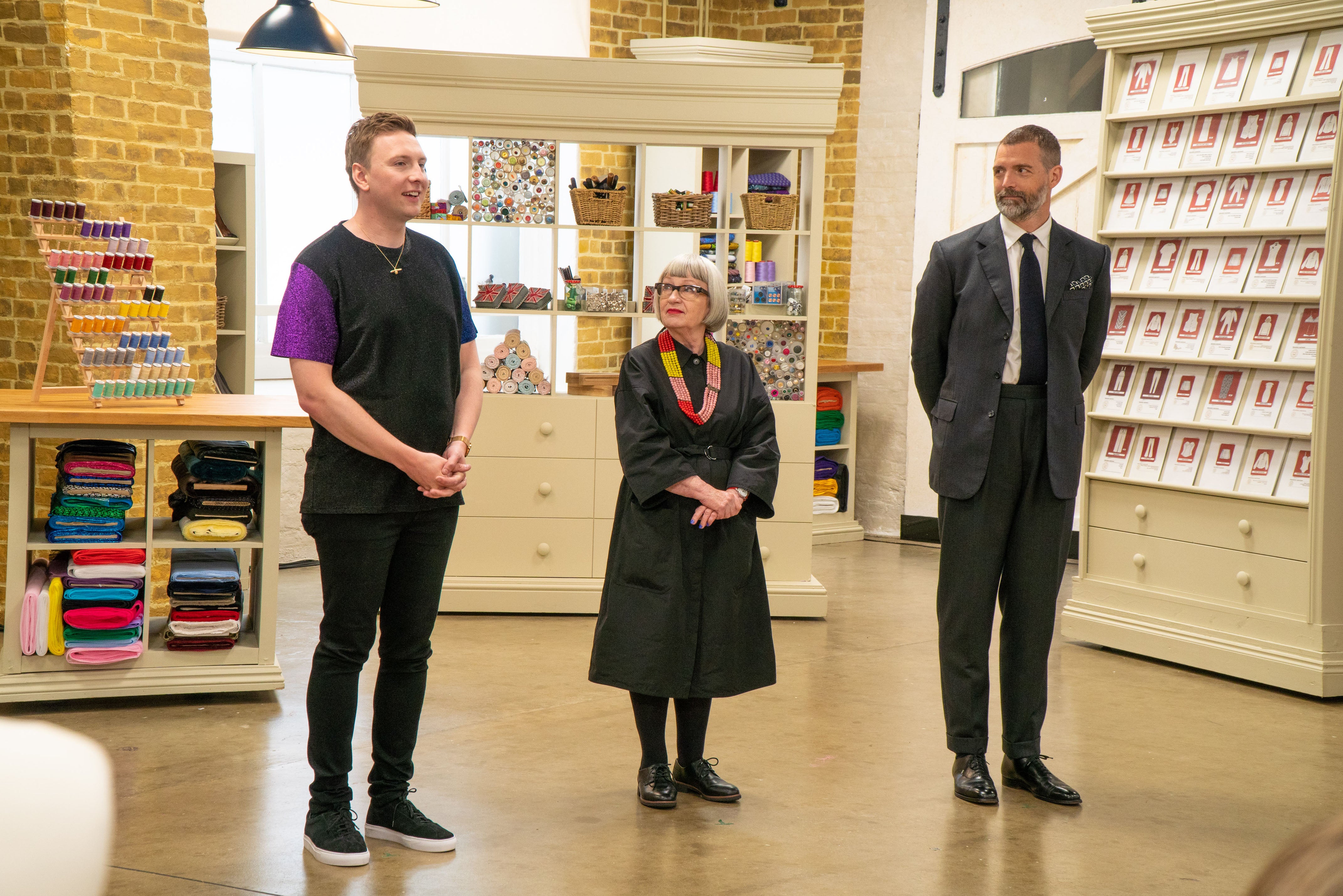 WARNING: Embargoed for publication until 00:00:01 on 06/04/2021 - Programme Name: The Great British Sewing Bee S7 - TX: n/a - Episode: The Great British Sewing Bee S7 - Ep1 (No. 1) - Picture Shows: **STRICTLY EMBARGOED NOT FOR PUBLICATION BEFORE 00:01 HRS ON TUESDAY 6TH APRIL 2021** Joe Lycett, Esme Young, Patrick Grant - (C) Love Productions - Photographer: Mark Bourdillon