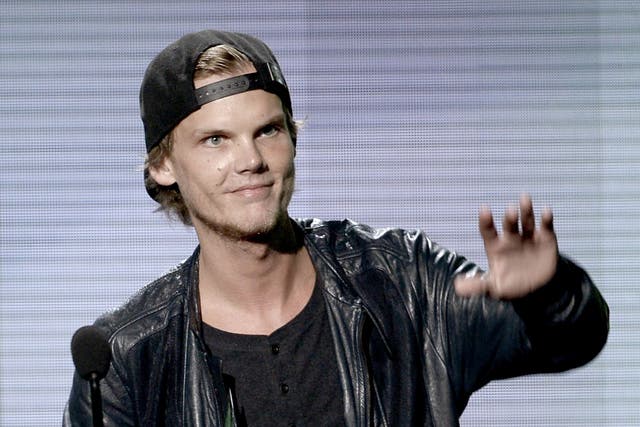 Avicii accepts the Favorite Electronic Dance Music Artist trophy at the American Music Awards on 24 November 2013 in Los Angeles, California
