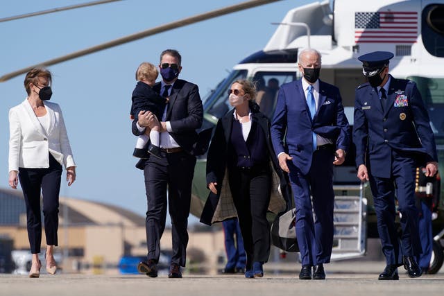 President Joe Biden walks with his son Hunter Biden before boarding Air Force One at Andrews Air Force Base on Friday, March 26, 2021.