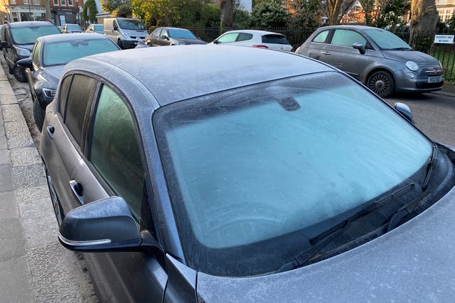 Frost covers cars early in the morning today in Kew, south-west London