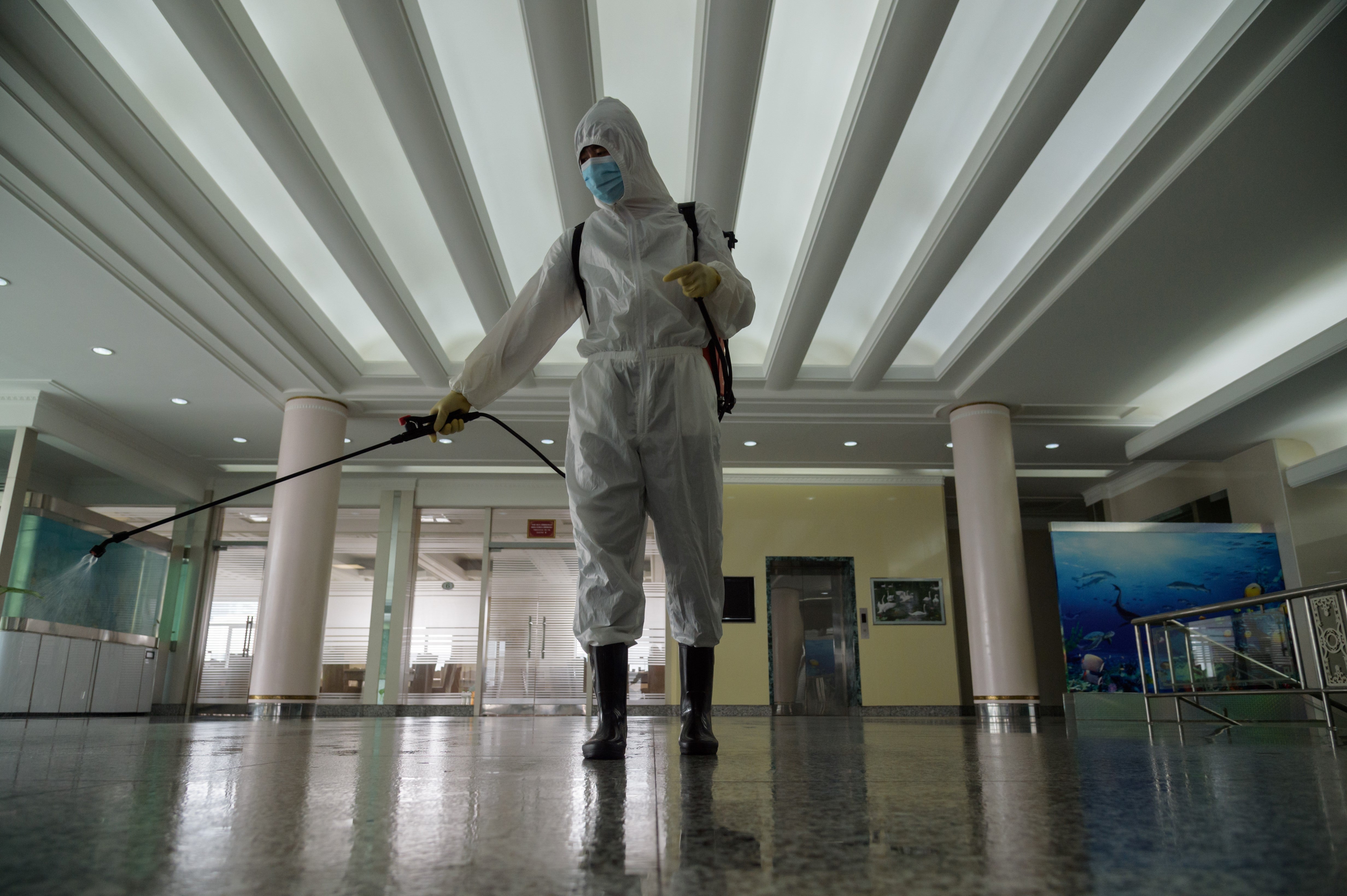 A health worker sprays disinfectant in a restaurant in Pyongyang on 21 October, 2020.