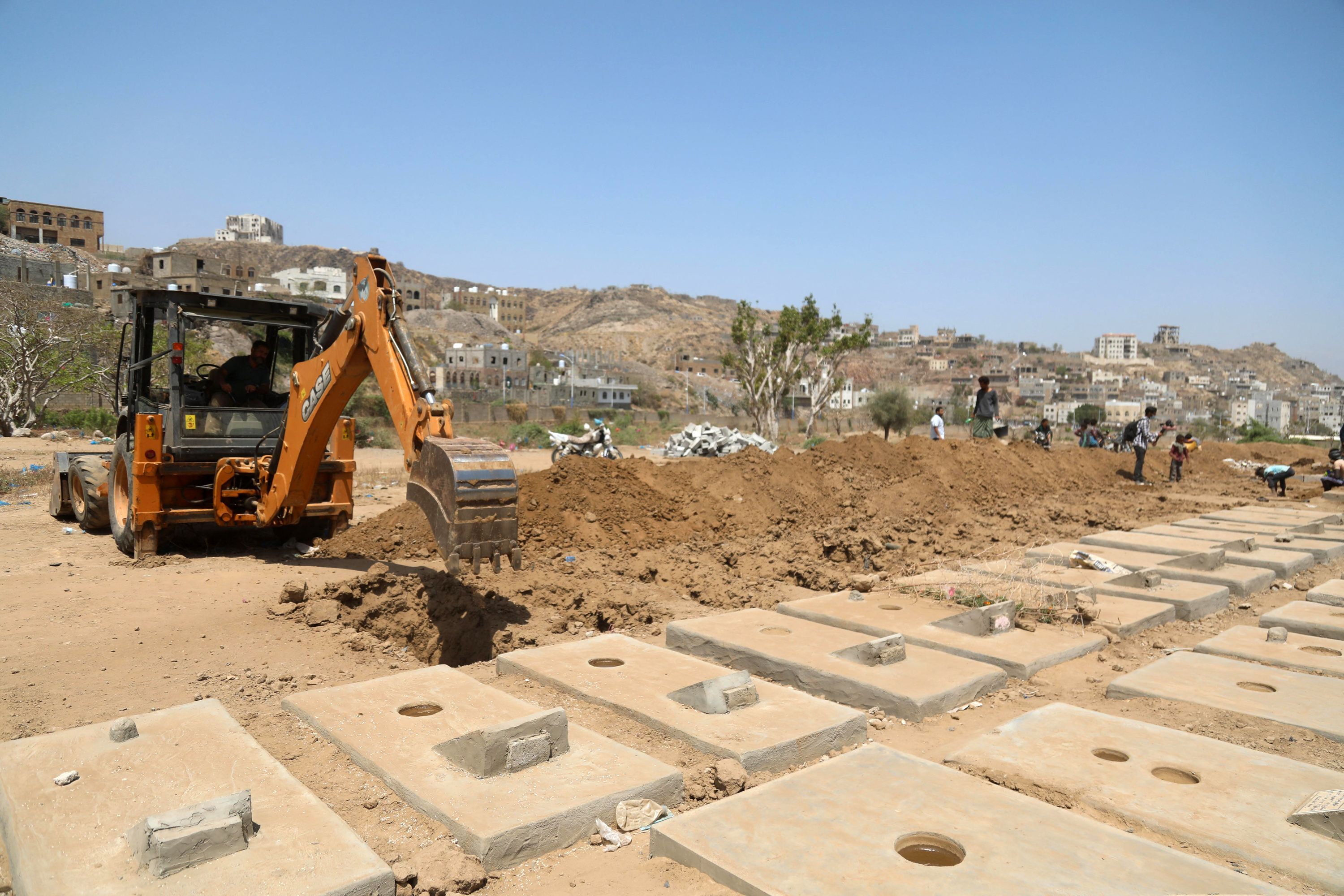 Graves for coronavirus victims are dug at a cemetery in Taez, Yemen, on 3 April, 2021.