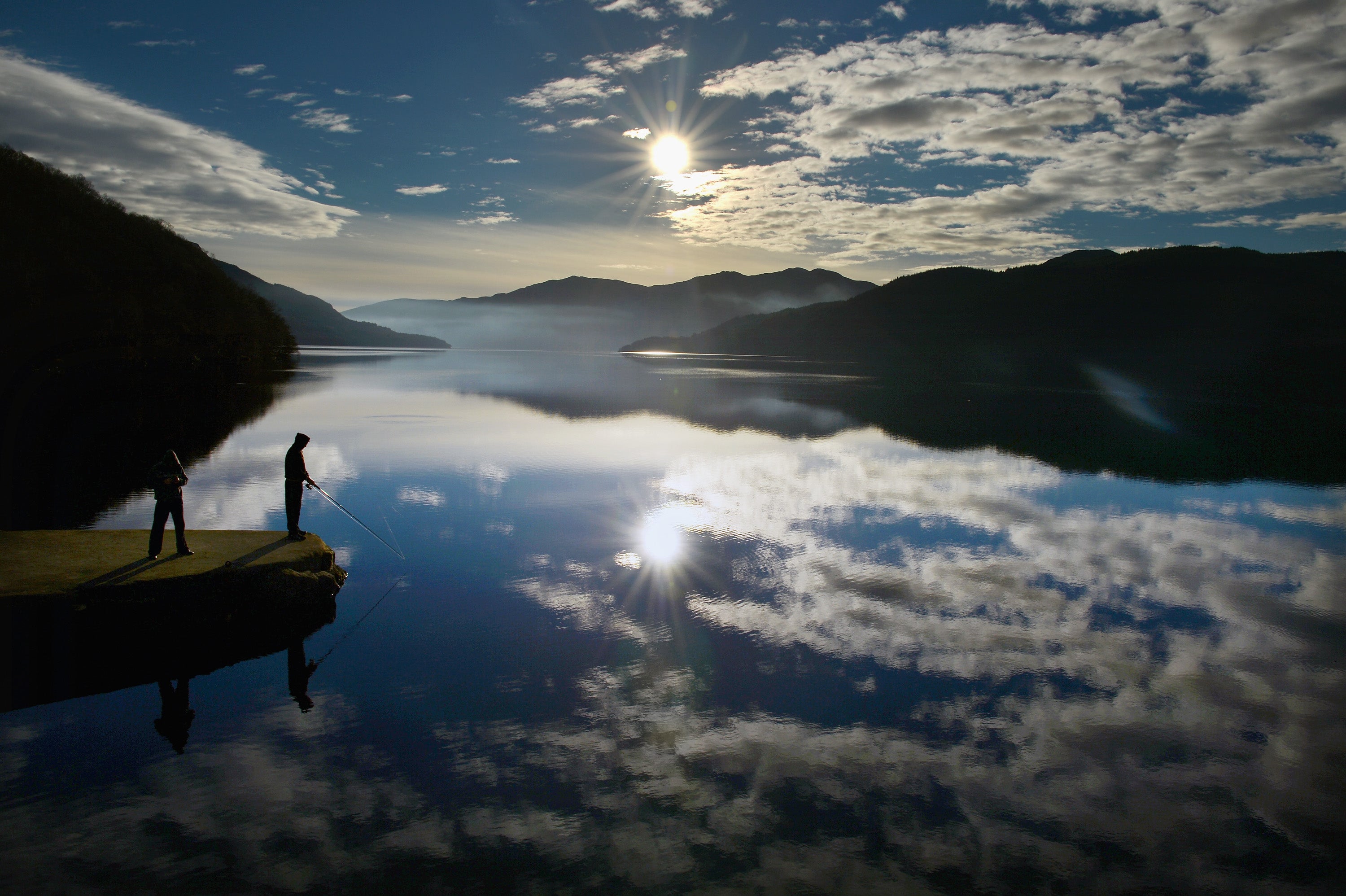 People fish from Inversnaid Pier in Loch Lomond, Scotland (stock image)