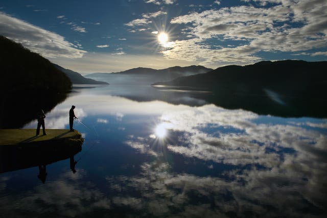People fish from Inversnaid Pier in Loch Lomond, Scotland (stock image)