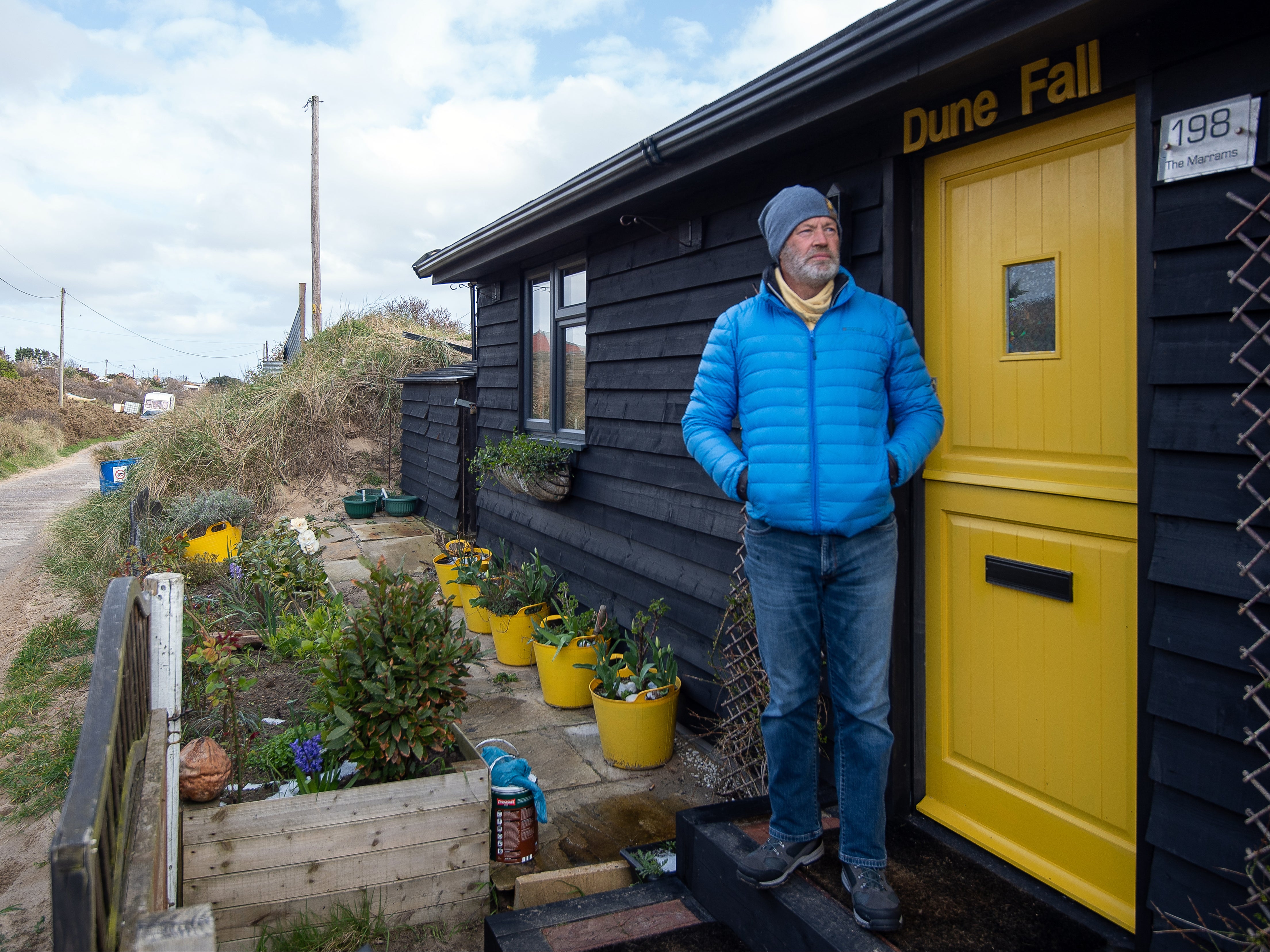 Martin stands outside the front of his home in Hemsby