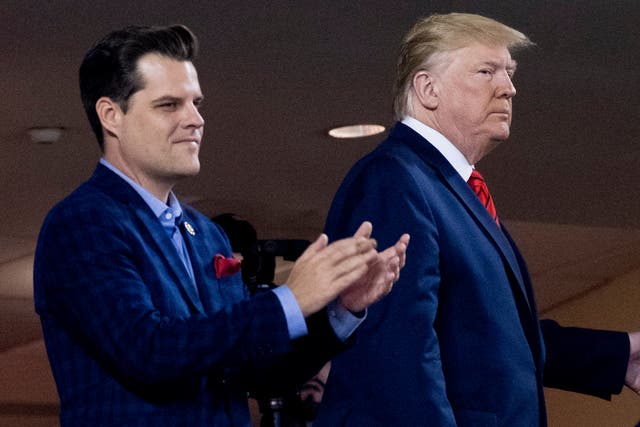  Donald Trump, right, accompanied by Rep. Matt Gaetz, R-Fla., left, arrive for Game 5 of the World Series baseball game between the Houston Astros and the Washington Nationals at Nationals Park in Washington.