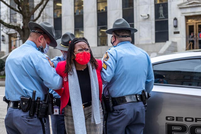 <p>State Rep. Park Cannon, D-Atlanta, is placed into the back of a Georgia State Capitol patrol car after being arrested by Georgia State Troopers at the Georgia State Capitol Building in Atlanta, Thursday, March 25, 2021.</p>