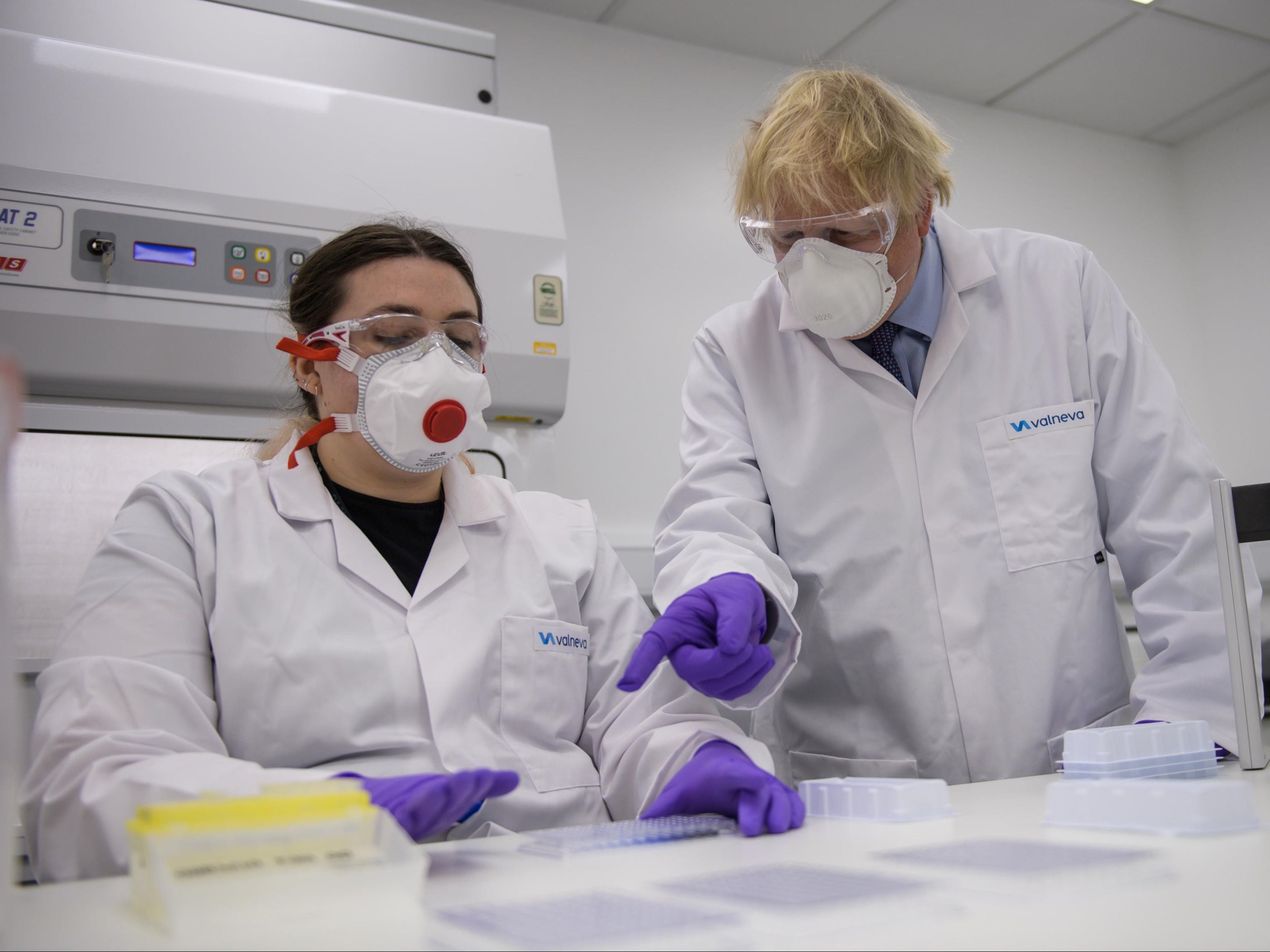 Prime Minister Boris Johnson with quality control technician Kerri Symington as he visits the French biotechnology laboratory Valneva in Livingston