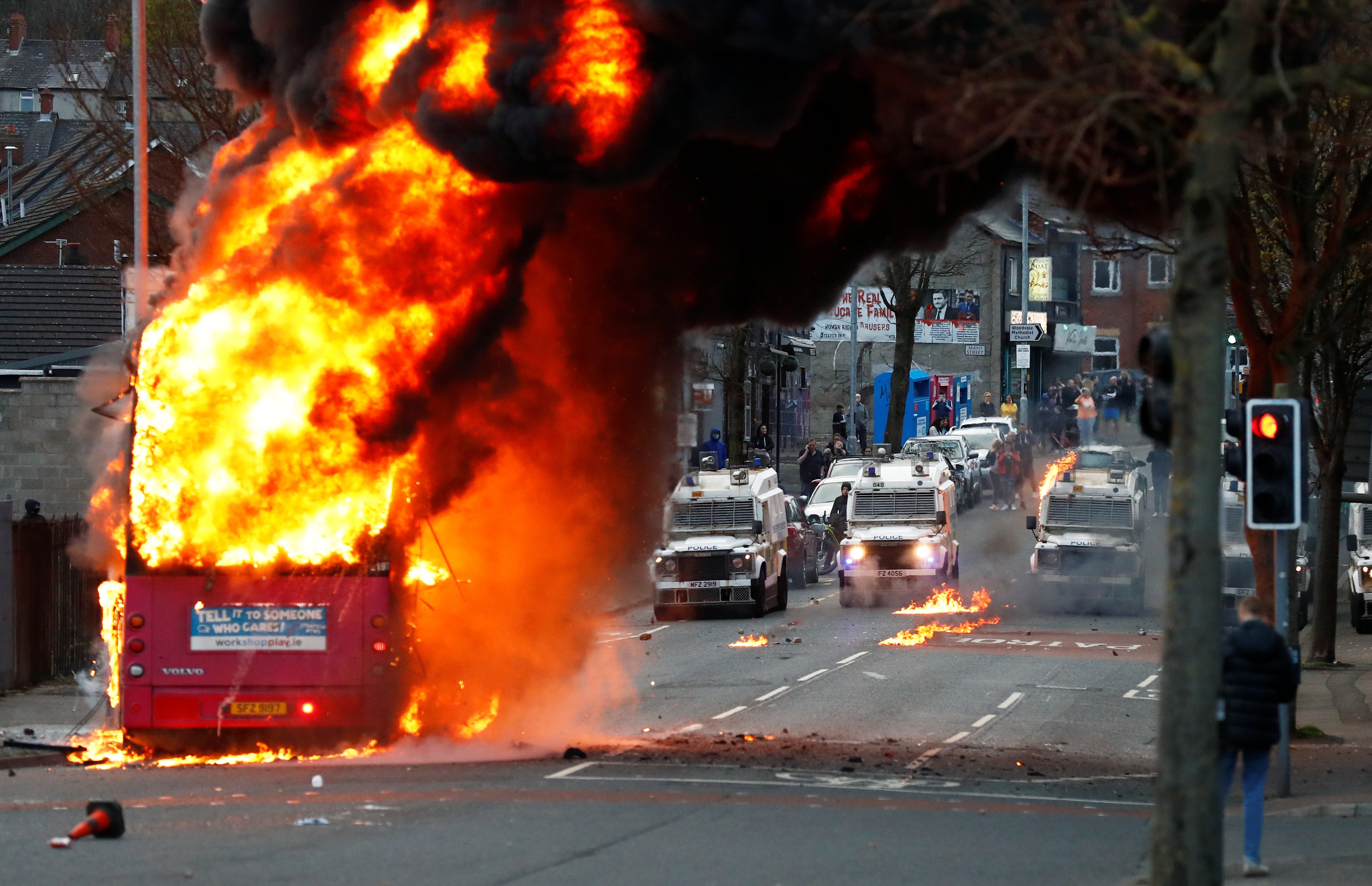 A hijacked bus burns on the Shankill Road as protests continue in Belfast on Wednesday evening