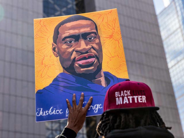 In this file photo demonstrators hold signs honouring George Floyd and other victims of racism as they gather during a protest outside Hennepin County Government Centre on 28 March 2021 in Minneapolis, Minnesota