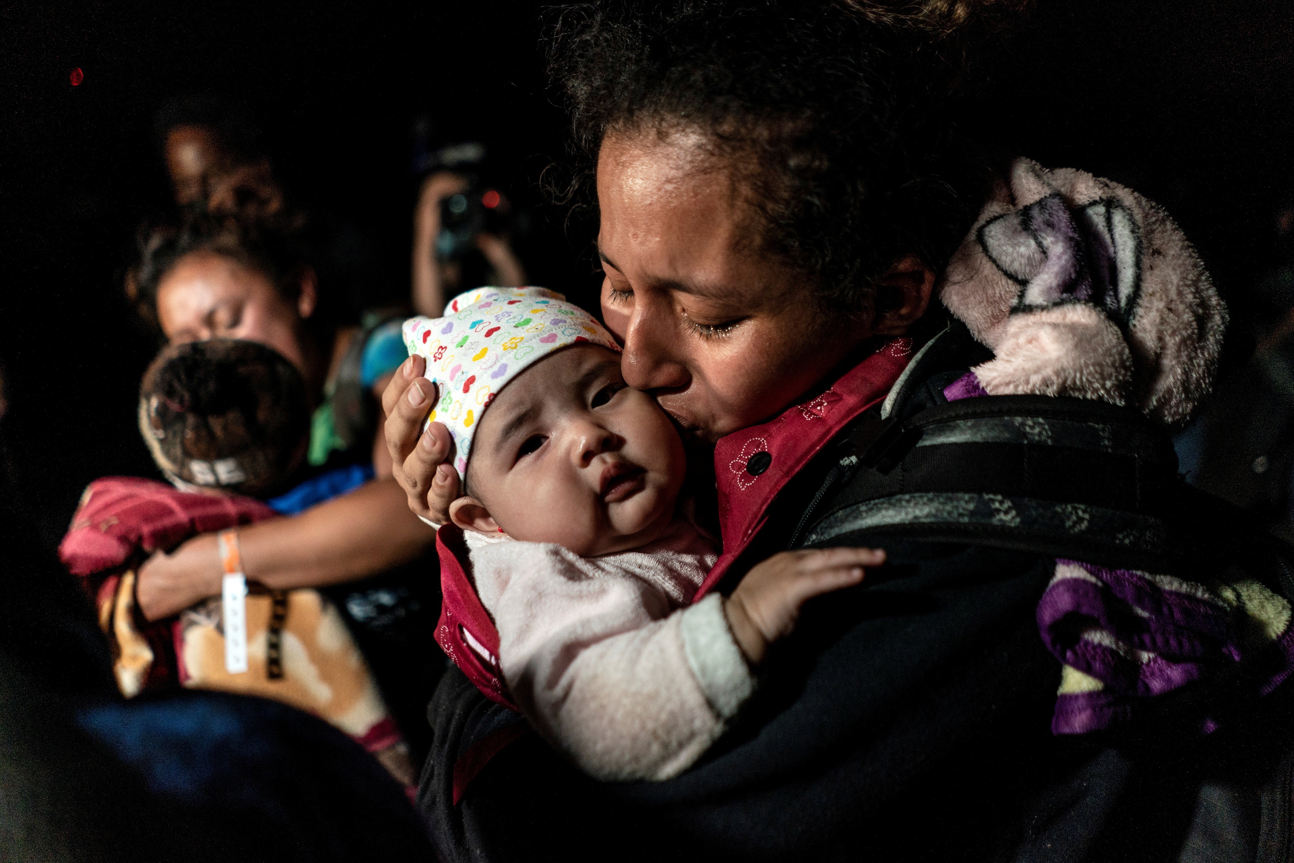 Refugees and migrants cross the Rio Grande river in Roma, Texas