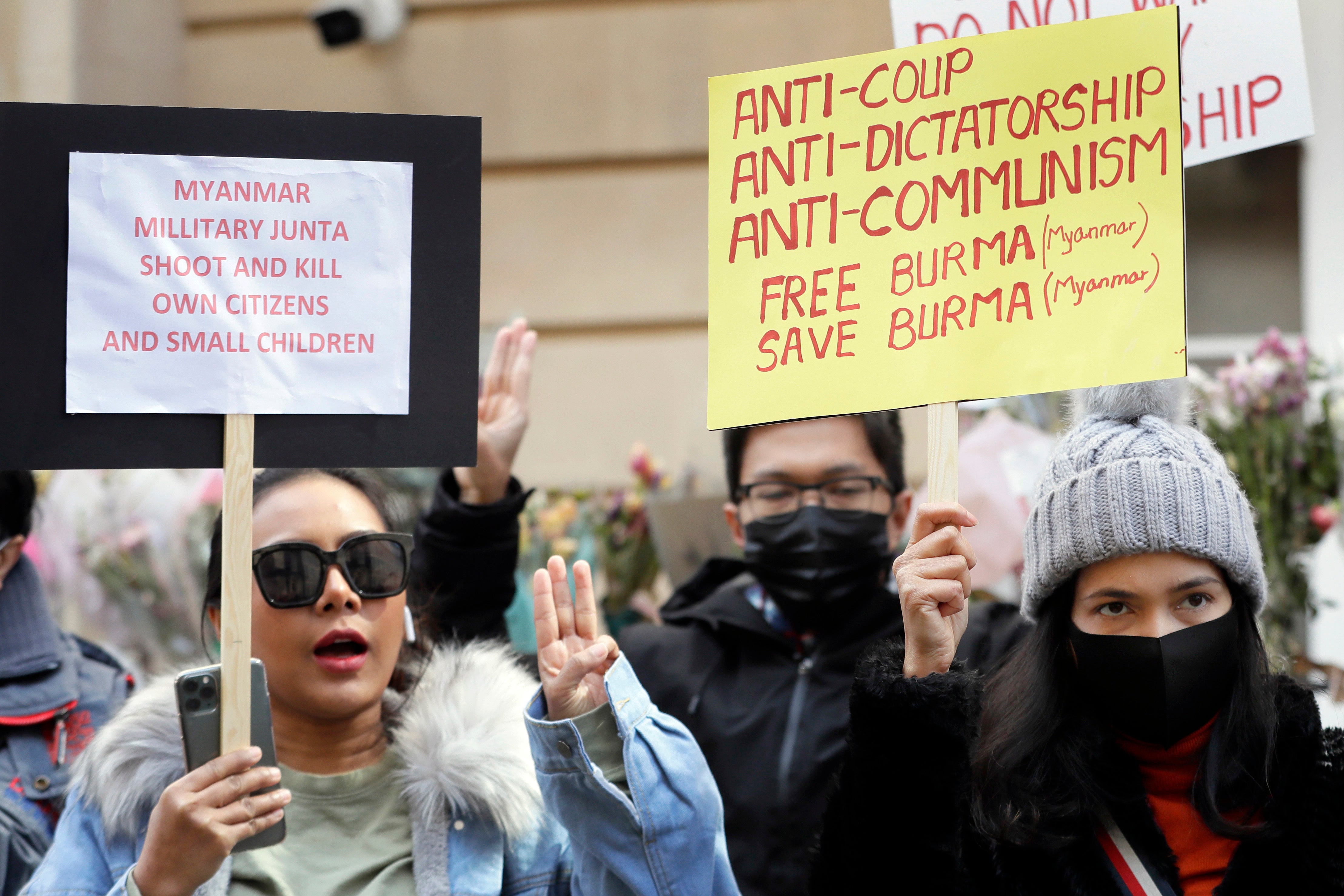 Demonstrators hold banners outside the Myanmar embassy in London on Thursday