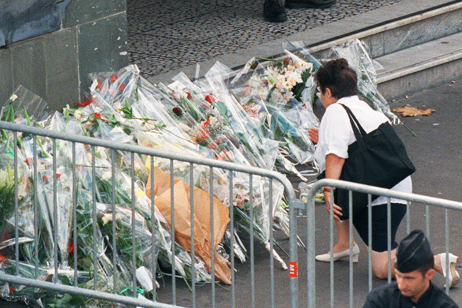 A woman places flowers in front of the Pitie Salpetriere hospital in Paris where Diana was admitted following the fatal crash