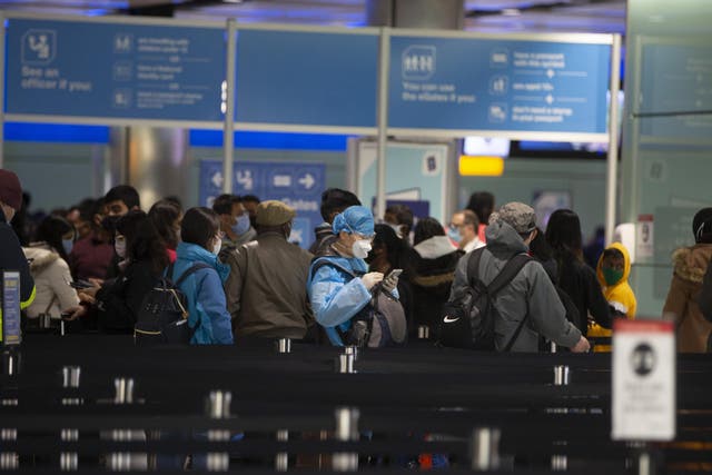 <p>People queue at UK border control at Heathrow’s Terminal 2 in February</p>
